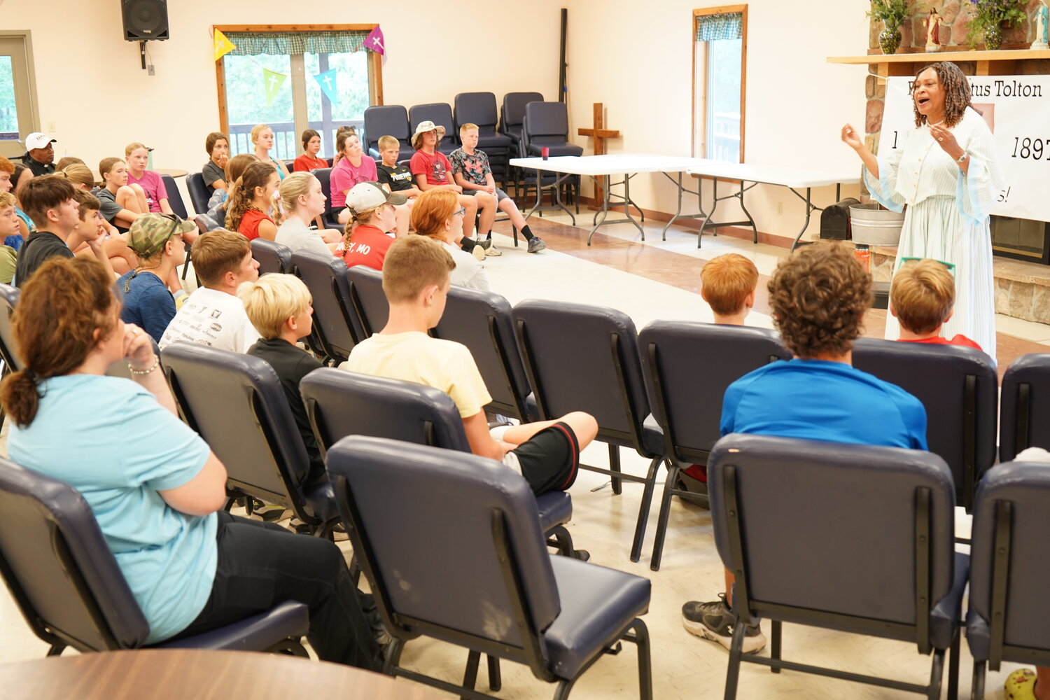 Participants in this year’s Camp Tolton in Clarence listen to Mett Morris tell the story of Venerable Father Augustus Tolton through the lens of his mother, Martha Jane Tolton.